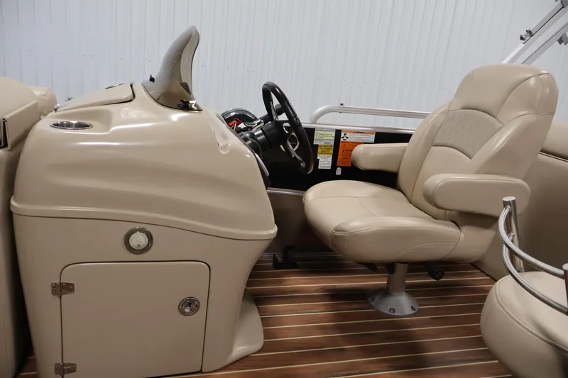 Slide: The Image of 2016 Berkshire 23E STS boat interior with beige captain's chair and wooden flooring. - 18