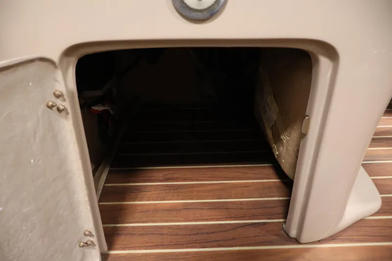 Slide: The Image of Storage compartment on a 2016 Berkshire 23E STS boat with wooden flooring. - 19