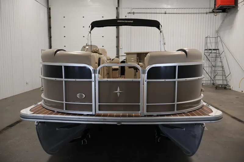 Slide: The Image of 2016 Berkshire 23E STS pontoon boat in indoor storage facility. - 2