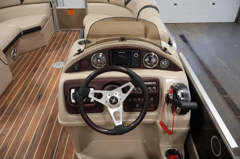 Slide: The Image of 2016 Berkshire 23E STS boat dashboard with steering wheel and control panel. - 20