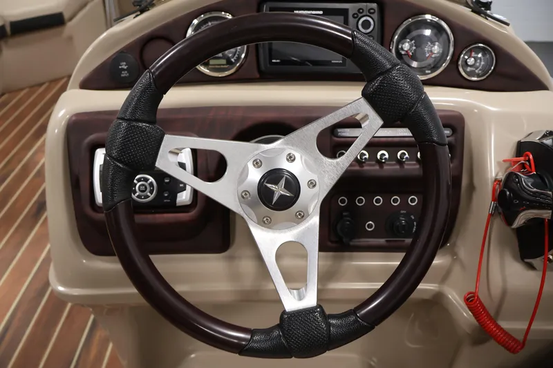 Slide: The Image of Steering wheel and dashboard of a 2016 Berkshire 23E STS boat. - 21
