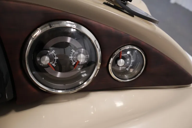 Slide: The Image of Dashboard gauges of a 2016 Berkshire 23E STS boat, featuring fuel and voltage indicators. - 25