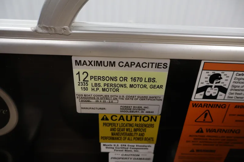 Slide: The Image of Maximum capacity label on 2016 Berkshire 23E STS boat, indicating weight and passenger limits. - 28