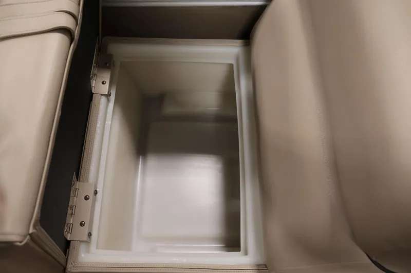 Slide: The Image of 2016 Berkshire 23E STS storage compartment with beige interior and hinged lid. - 31