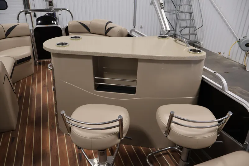 Slide: The Image of Interior of a 2016 Berkshire 23E STS pontoon boat with bar and seating area. - 32