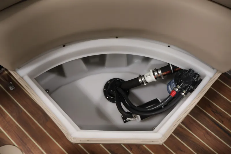 Slide: The Image of 2016 Berkshire 23E STS boat storage compartment with plumbing components. - 36