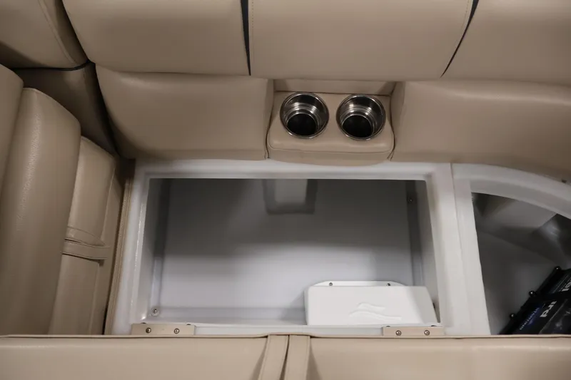 Slide: The Image of Interior storage compartment with cup holders in a 2016 Berkshire 23E STS boat. - 38
