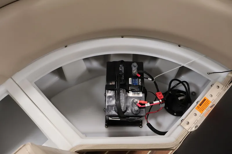 Slide: The Image of Battery compartment of a 2016 Berkshire 23E STS boat, featuring wiring and safety label. - 39