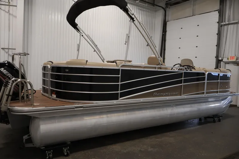 Slide: The Image of 2016 Berkshire 23E STS pontoon boat in indoor storage, featuring a sleek design. - 4