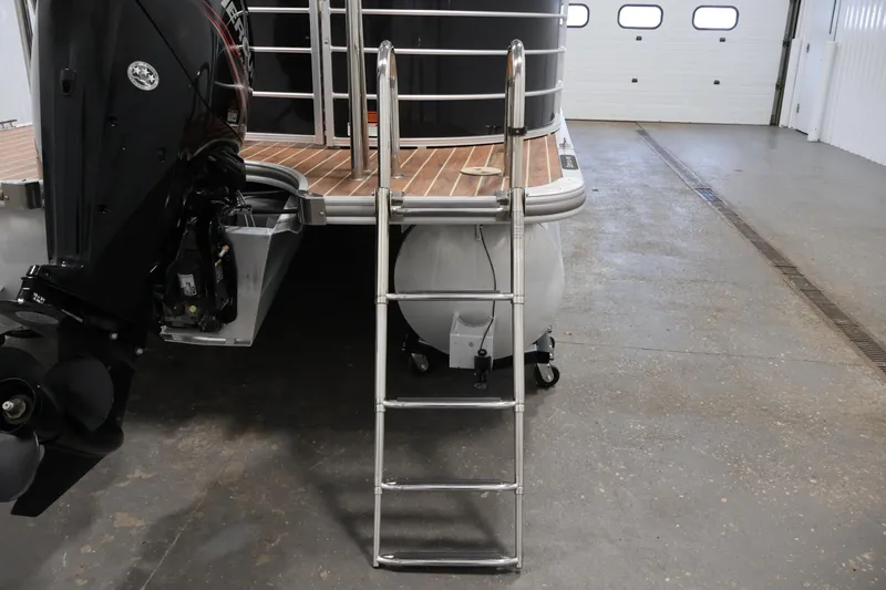 Slide: The Image of 2016 Berkshire 23E STS boat with ladder and outboard motor in a garage. - 41
