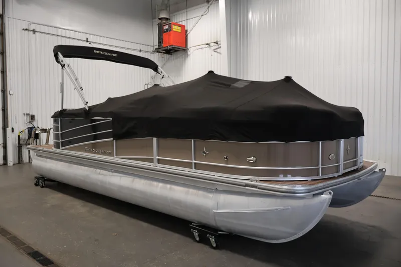 Slide: The Image of 2016 Berkshire 23E STS pontoon boat with black cover in indoor storage. - 46
