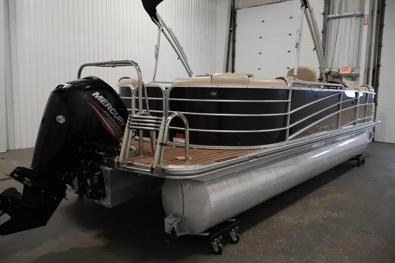 Slide: The Image of 2016 Berkshire 23E STS pontoon boat with Mercury outboard motor in indoor storage. - 5