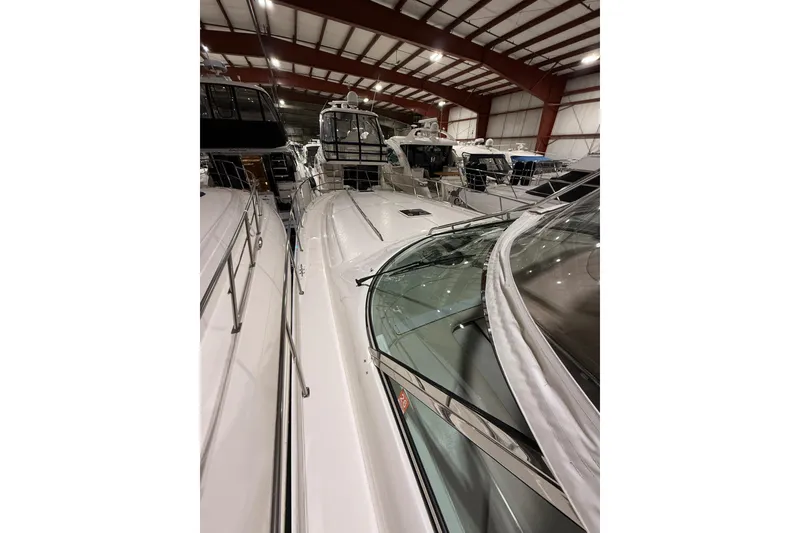 Slide: The Image of 2000 Sea Ray Sundancer 540 yacht in indoor storage, showcasing sleek design and spacious deck. - 10