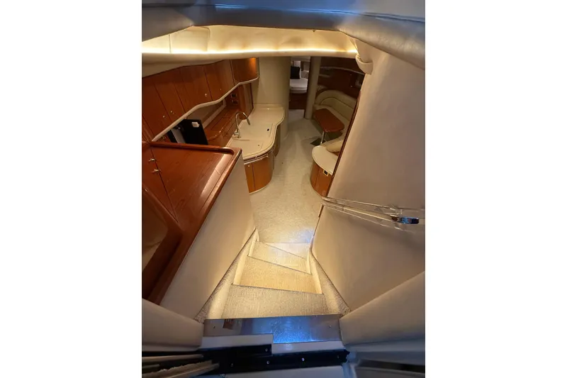 Slide: The Image of Interior view of 2000 Sea Ray Sundancer 540 yacht, featuring elegant wood cabinetry and seating. - 25