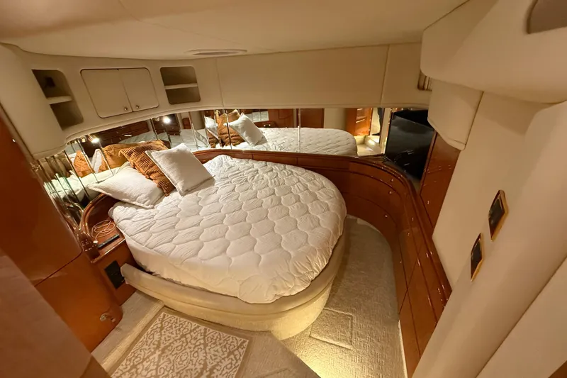 Slide: The Image of Luxurious bedroom interior of 2000 Sea Ray Sundancer 540 yacht with cozy bedding. - 29