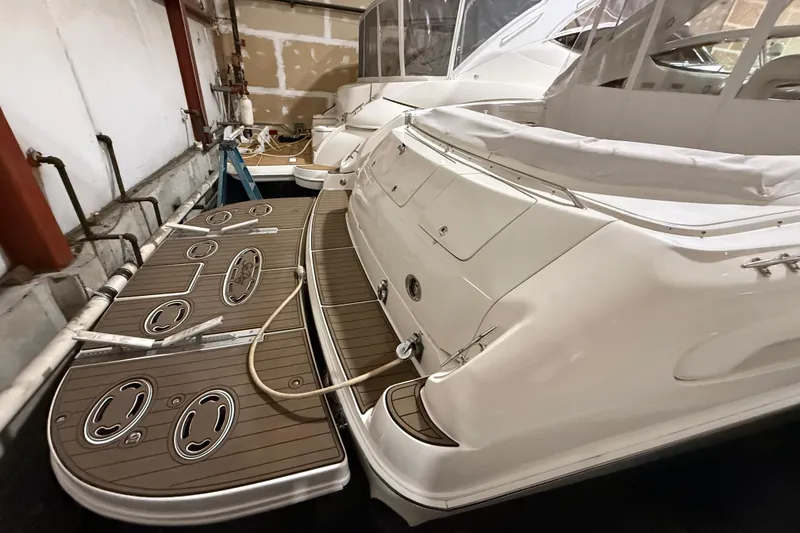 Slide: The Image of 2000 Sea Ray Sundancer 540 yacht in storage, showcasing rear deck and sleek design. - 3