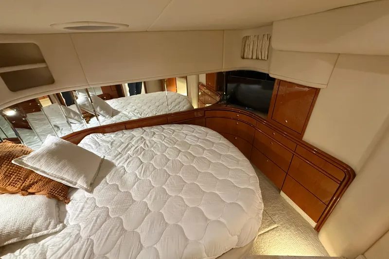 Slide: The Image of Luxurious bedroom interior of 2000 Sea Ray Sundancer 540 yacht with plush bedding. - 33
