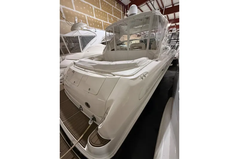 Slide: The Image of 2000 Sea Ray Sundancer 540 yacht in storage, showcasing sleek design and spacious deck. - 5