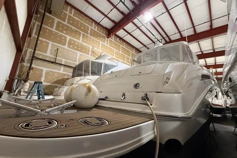 Slide: The Image of Sea Ray Sundancer 540 yacht from 2000 stored indoors, showcasing rear deck and hull. - 7