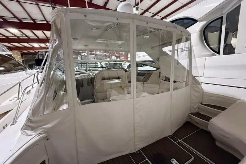 Slide: The Image of 2000 Sea Ray Sundancer 540 yacht with enclosed cockpit, docked indoors. - 8