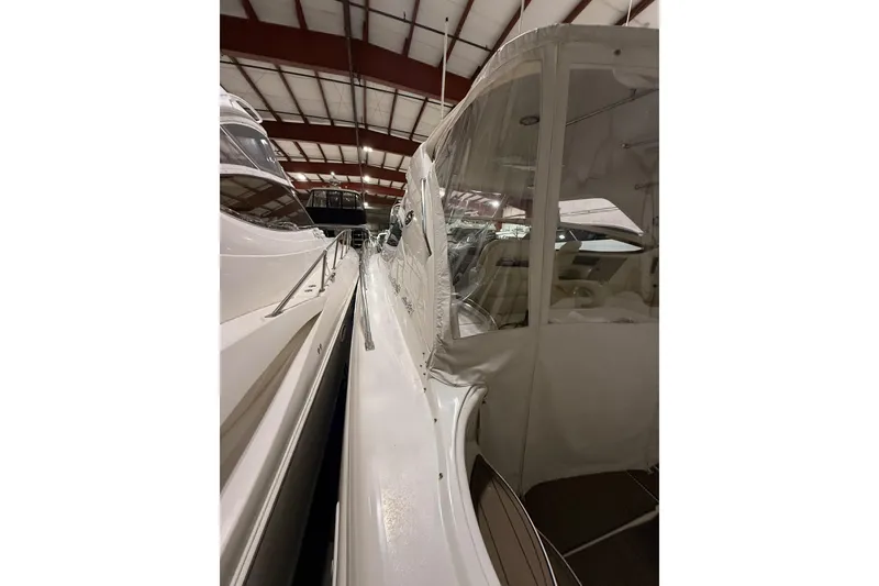 Slide: The Image of 2000 Sea Ray Sundancer 540 yacht in storage, showcasing sleek design and covered cockpit. - 9