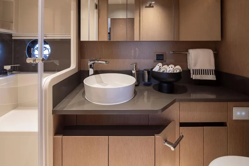 Slide: The Image of Luxurious bathroom in 2025 Sirena 48 yacht, featuring modern sink and elegant wood cabinetry. - 15
