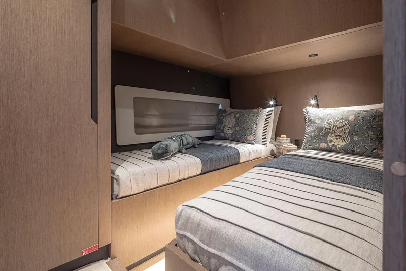 Slide: The Image of Interior of 2025 Sirena 48 yacht cabin with twin beds and modern decor. - 19