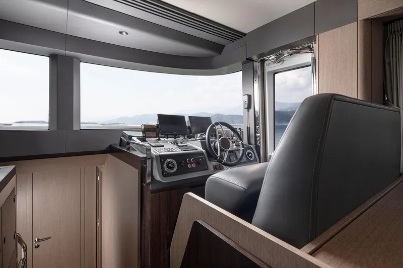 Slide: The Image of Interior of 2025 Sirena 48 yacht cockpit with modern steering and navigation equipment. - 9