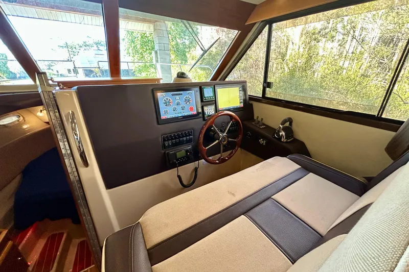 Slide: The Image of Interior helm of 2016 Cutwater C-30 CB boat with navigation controls and steering wheel. - 12