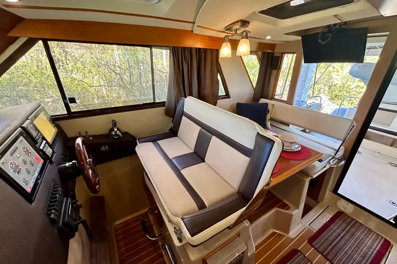 Slide: The Image of Interior of 2016 Cutwater C-30 CB boat with helm, seating, and dining area. - 13