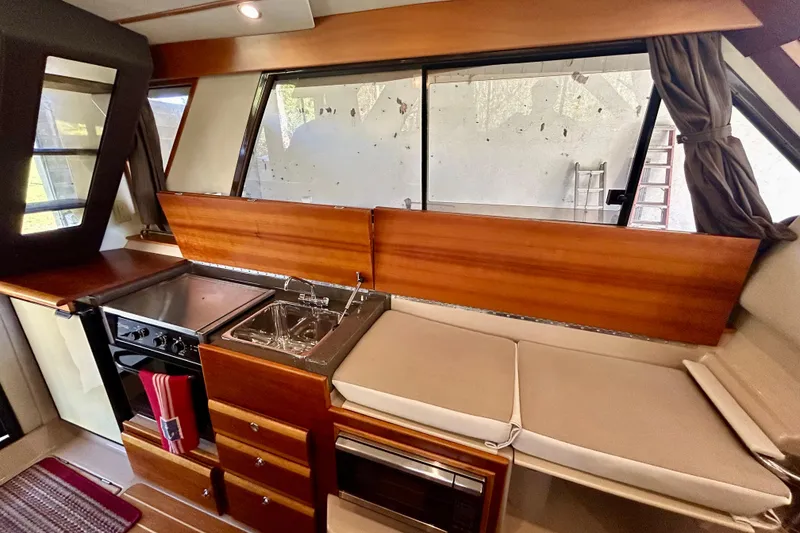 Slide: The Image of 2016 Cutwater C-30 CB boat interior with kitchen, stove, sink, and seating area. - 17