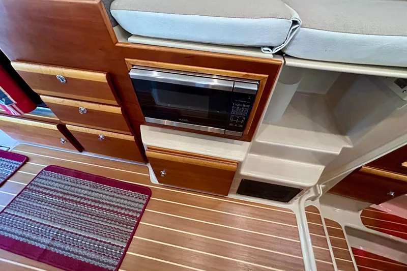 Slide: The Image of Interior of 2016 Cutwater C-30 CB boat with microwave and wooden cabinetry. - 21