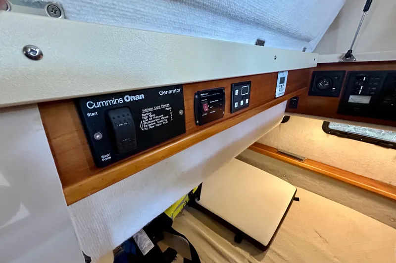Slide: The Image of Control panel inside 2016 Cutwater C-30 CB boat featuring Cummins Onan generator. - 23