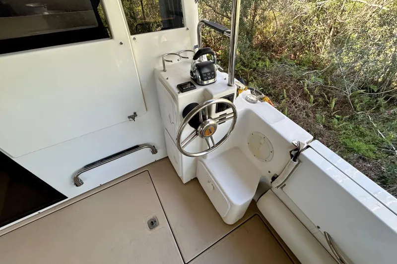 Slide: The Image of Helm station of 2016 Cutwater C-30 CB boat with steering wheel and controls. - 27