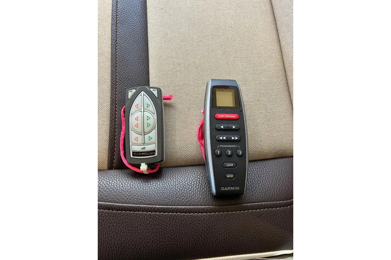 Slide: The Image of Two remote controls on a boat seat, including a Garmin device. - 34
