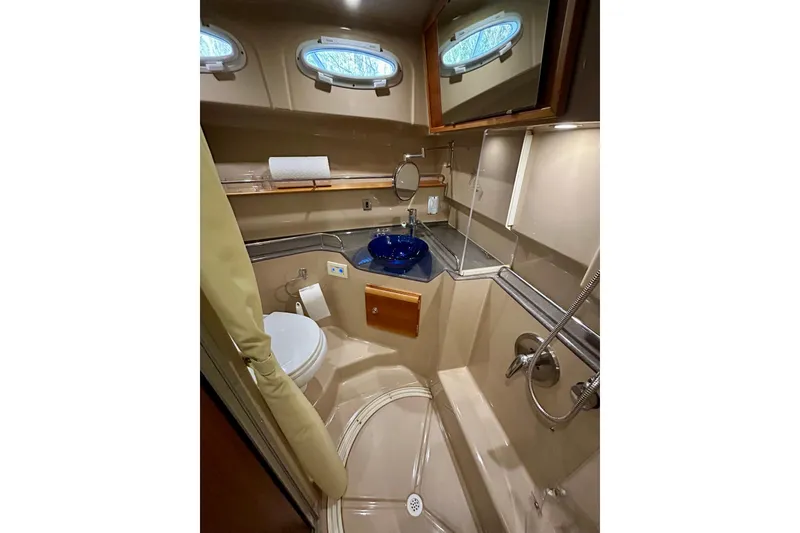 Slide: The Image of 2016 Cutwater C-30 CB yacht bathroom with modern fixtures and blue glass sink. - 9