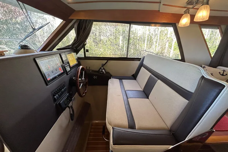 Slide: The Image of Interior of a 2016 Cutwater C-30 CB boat with helm and seating area. - 14