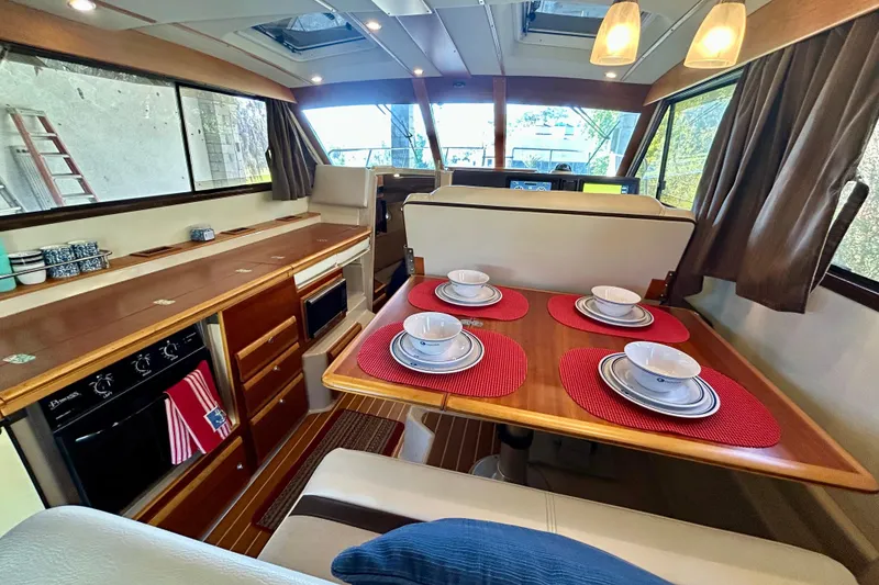 Slide: The Image of Interior of 2016 Cutwater C-30 CB yacht with dining area and kitchen amenities. - 15