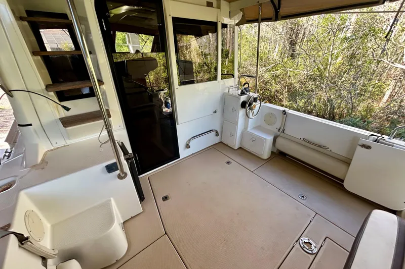 Slide: The Image of 2016 Cutwater C-30 CB boat interior with helm, seating, and stairs. - 28