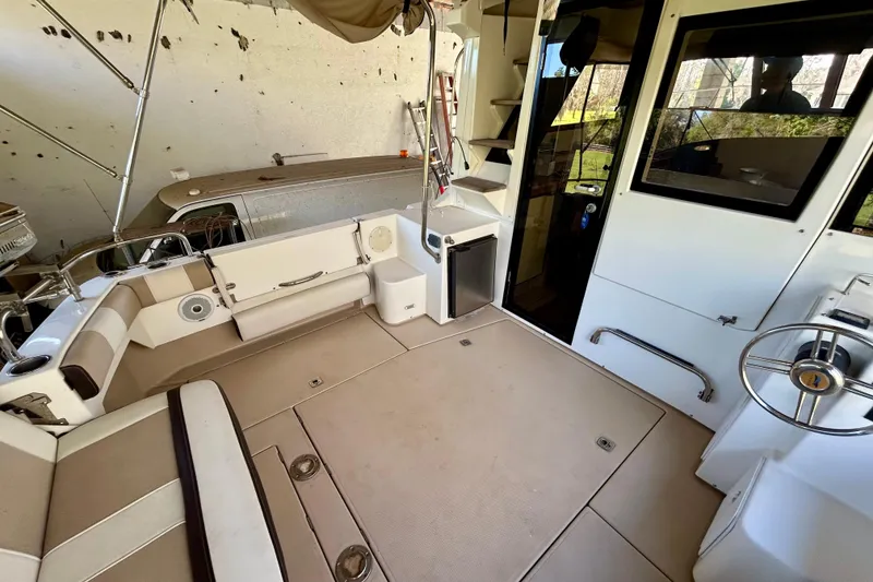 Slide: The Image of 2016 Cutwater C-30 CB boat interior with seating, steering wheel, and cabin entrance. - 29