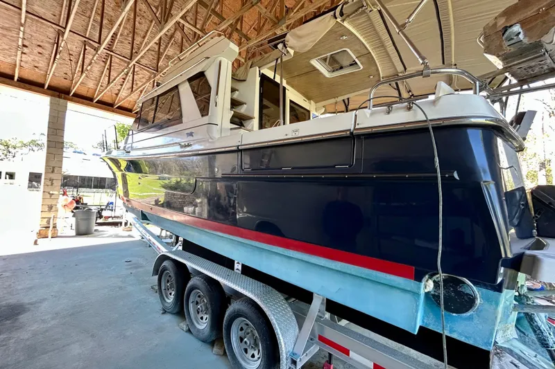 Slide: The Image of 2016 Cutwater C-30 CB boat on trailer in a covered storage area. - 3
