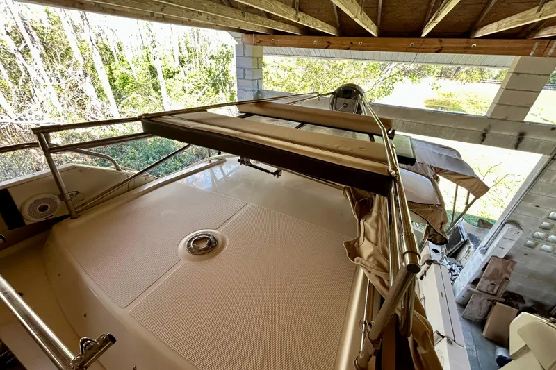Slide: The Image of 2016 Cutwater C-30 CB boat under shelter, featuring deck and railing. - 31