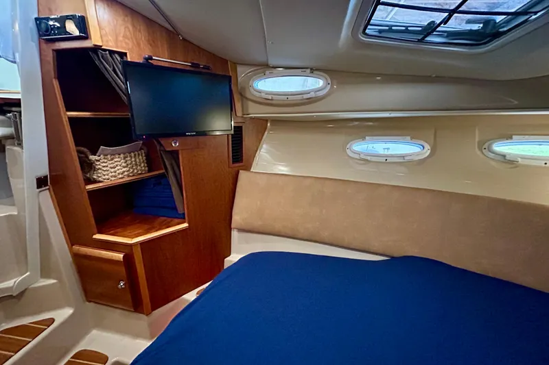 Slide: The Image of Cozy cabin interior of 2016 Cutwater C-30 CB with TV and storage shelves. - 7