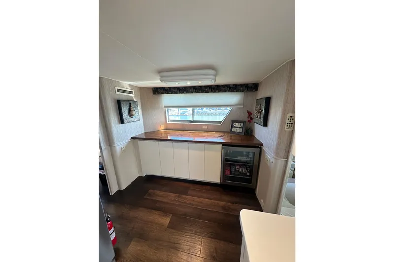 Slide: The Image of Interior of 1992 Hatteras 65 Motor Yacht with modern kitchenette and wood flooring. - 10