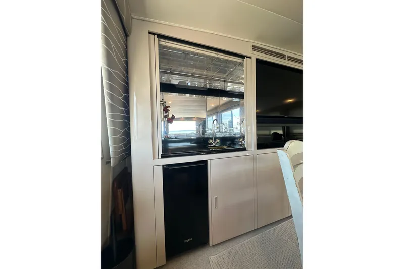 Slide: The Image of Interior of 1992 Hatteras 65 Motor Yacht with modern cabinetry and mirrored accents. - 11