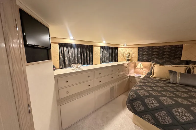 Slide: The Image of Luxurious bedroom interior of 1992 Hatteras 65 Motor Yacht with elegant decor and lighting. - 14