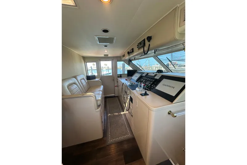 Slide: The Image of Interior of 1992 Hatteras 65 Motor Yacht helm with leather seating and navigation equipment. - 18