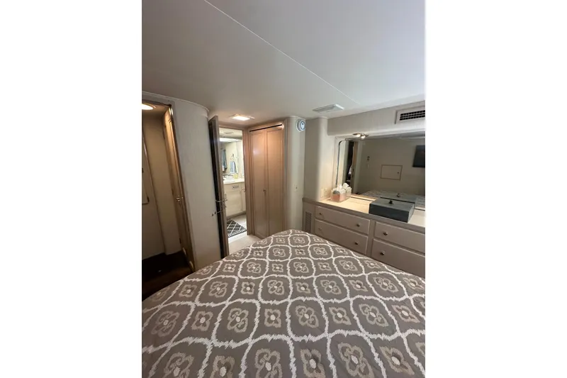 Slide: The Image of Interior of 1992 Hatteras 65 Motor Yacht bedroom with patterned bedding and dresser. - 20