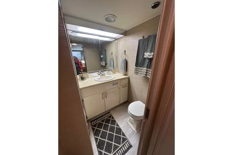 Slide: The Image of Bathroom interior of 1992 Hatteras 65 Motor Yacht with sink, mirror, and toilet. - 21