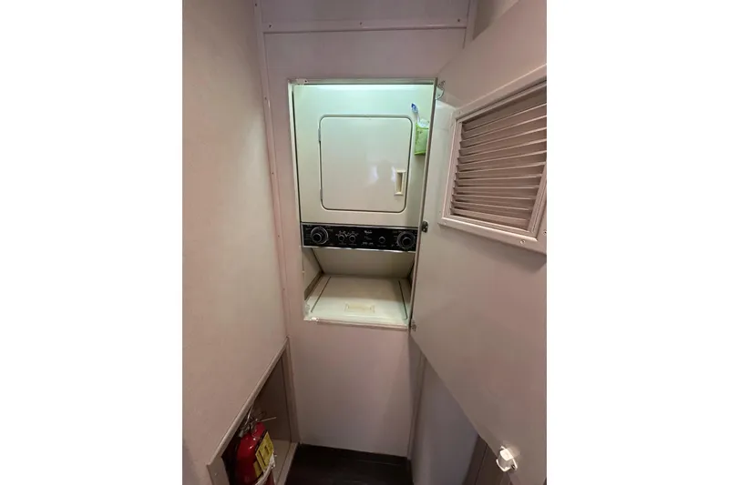 Slide: The Image of Laundry area with washer-dryer in 1992 Hatteras 65 Motor Yacht. - 23